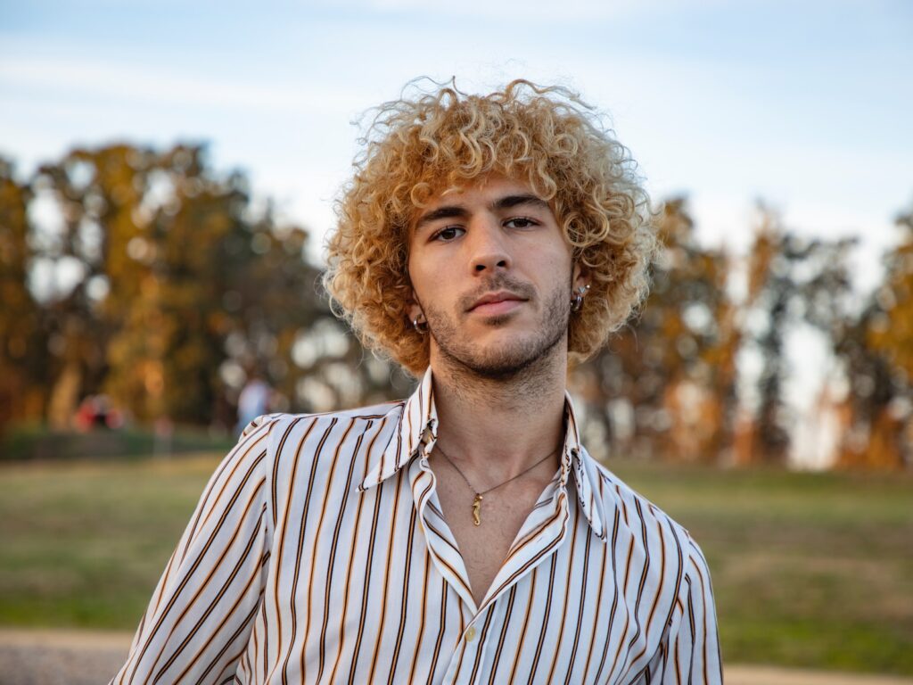 A Minnesota man who has experienced crime with curly hair wearing a striped shirt